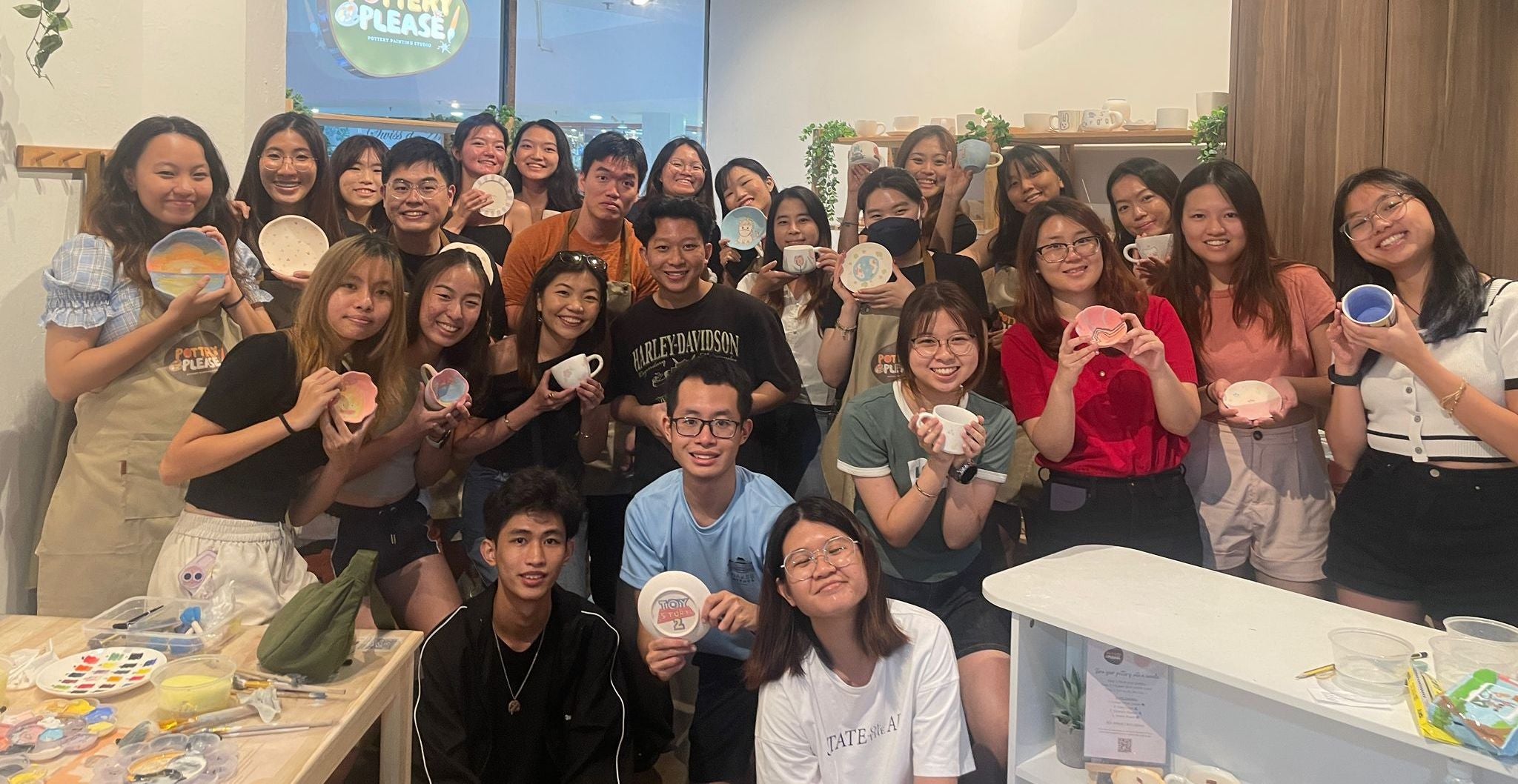 Students participating in a school-hosted pottery painting event at PotteryPlease! studio in Singapore